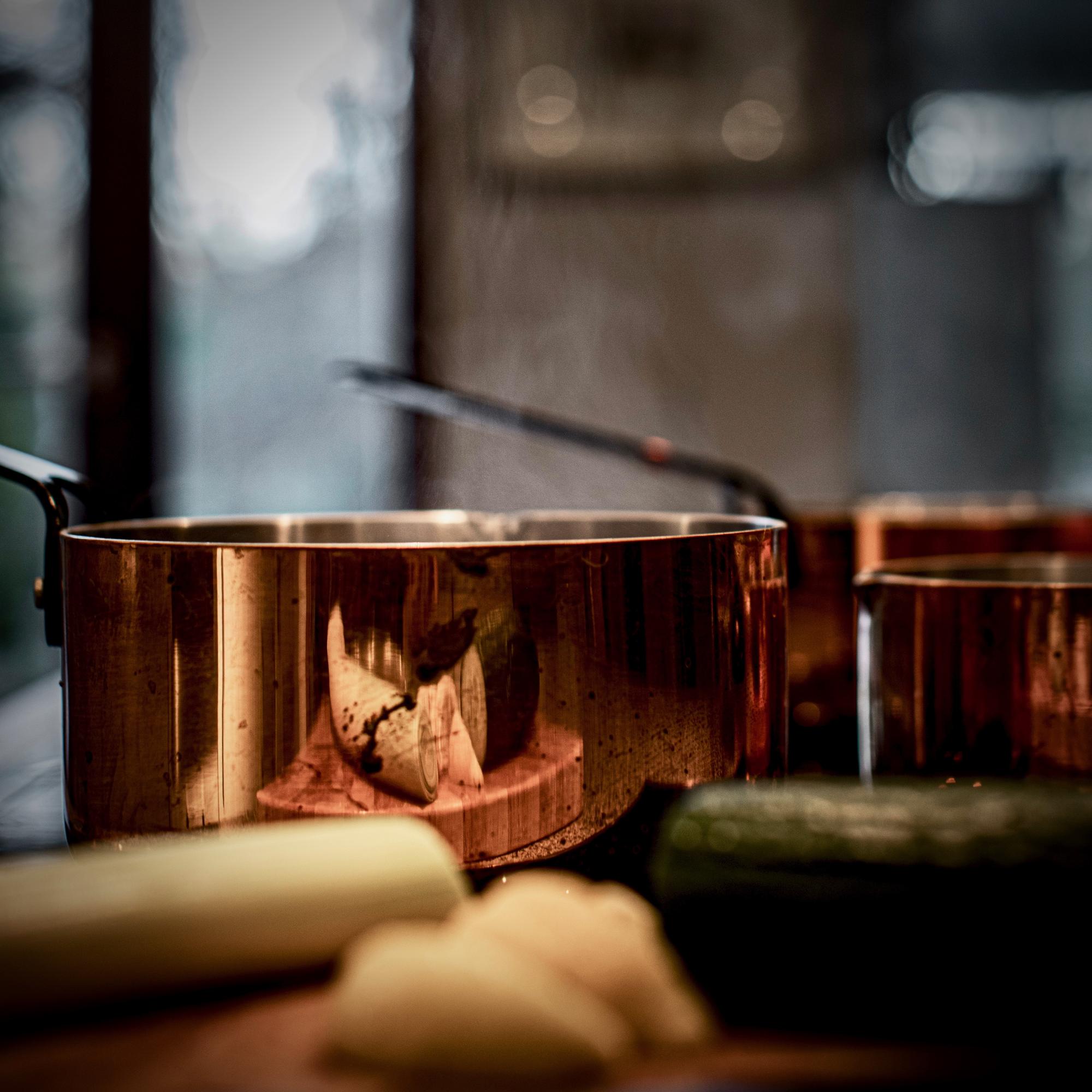 Studio kitchen with copper pans and herbs